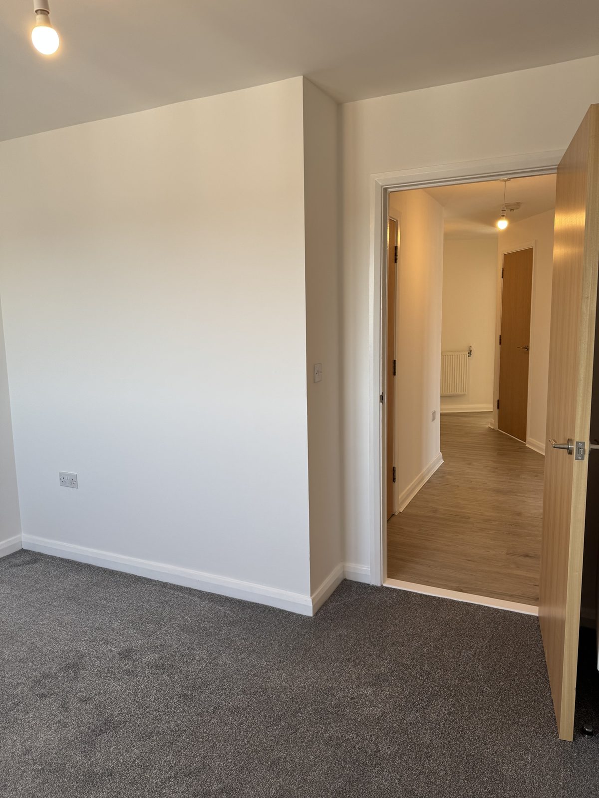 Fitted eaves cupboard opened through to the adjoining room