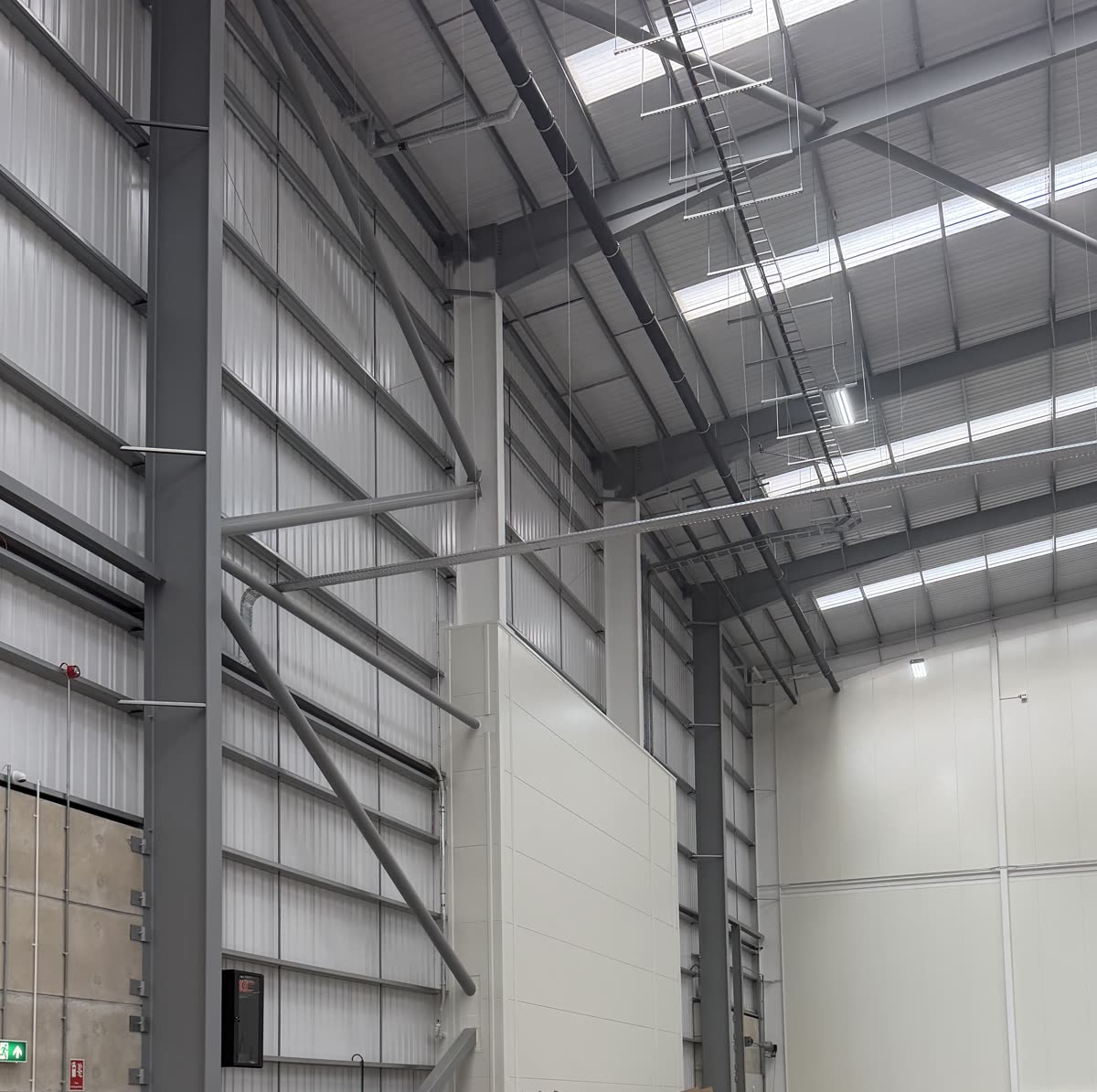 Steel portal frame and roof lights inside the warehouse under conversion