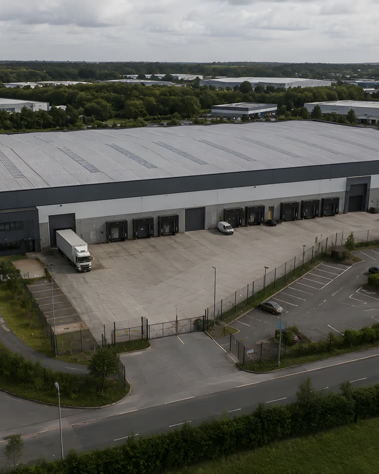 Aerial view of the commercial warehouse under conversion, with its loading bays and yard